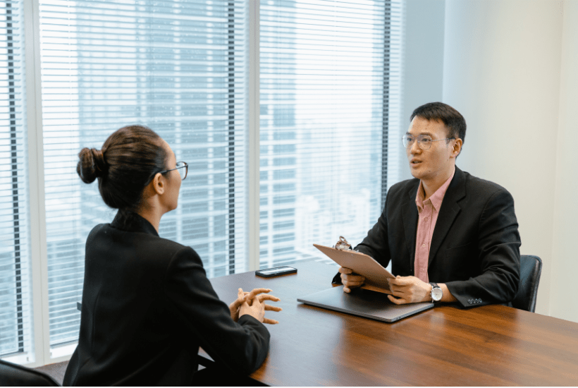 Team leader interviewing an agent across a desk